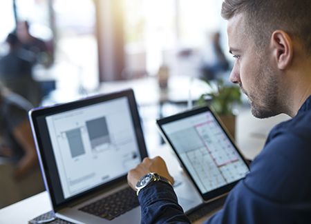 Business man looking and analyzing projects on his laptop comput