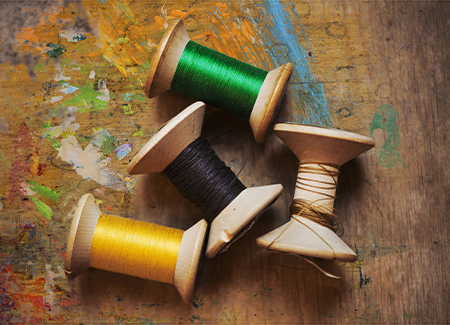 Bobbins of wound thread, silks and cottons in bright colours. ,Watlington,England